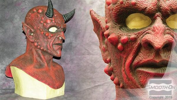 Demon bust sculpture with horns.