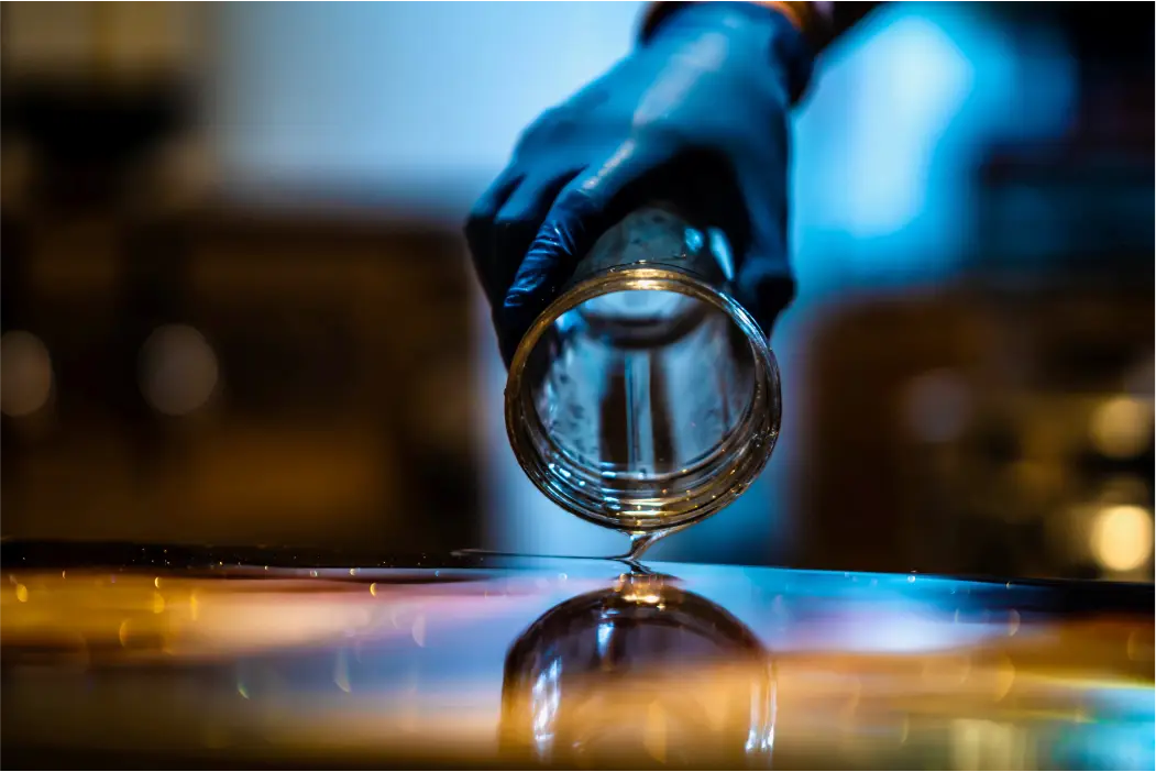 Hand pouring liquid from jar